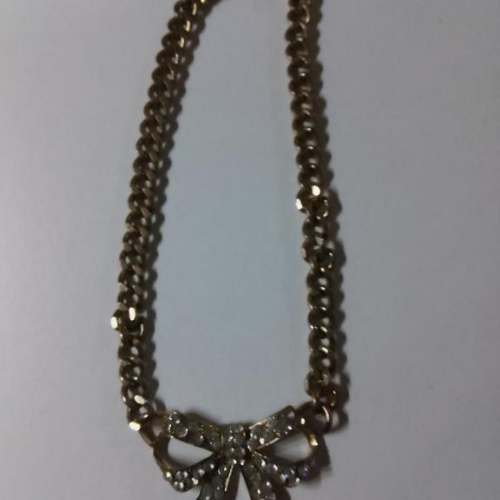 gold chunky necklace with big diamond bow pendant