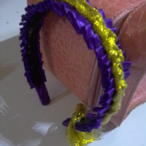 purple folded ribbon detail with gold braid 